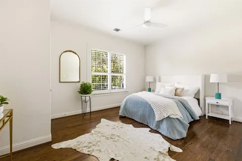 a spacious bedroom with a bed and a window