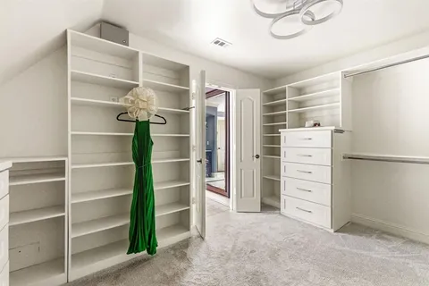 a view of walk in closet with empty racks