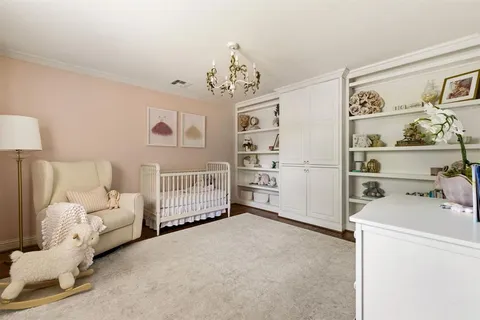 a bedroom with furniture and a chandelier