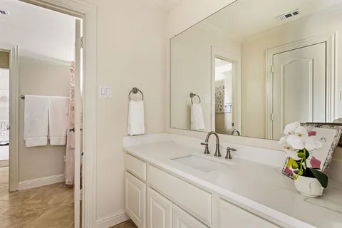 a bathroom with a sink double vanity and a mirror