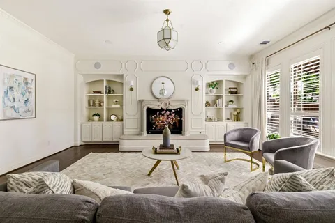 a living room with furniture a clock and a window