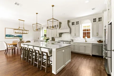 a kitchen with appliances a sink a counter top space and cabinets