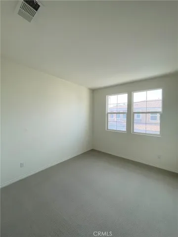 an empty room with a ceiling fan