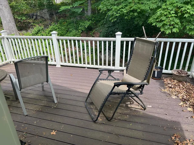 a view of balcony with wooden floor and outdoor seating
