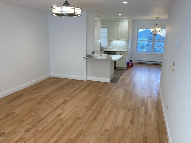 a view of kitchen and dining room with wooden floor