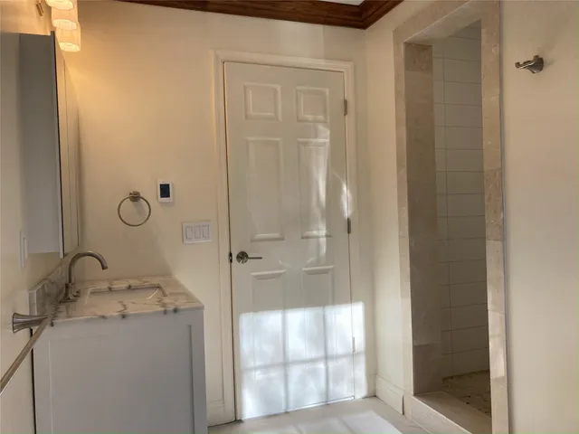 a bathroom with a granite countertop sink and shower