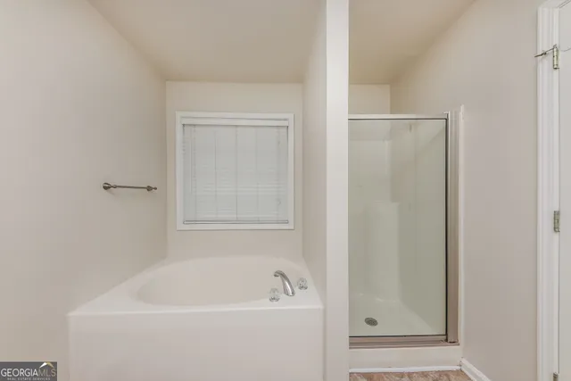a white bath tub sitting next to a white sink