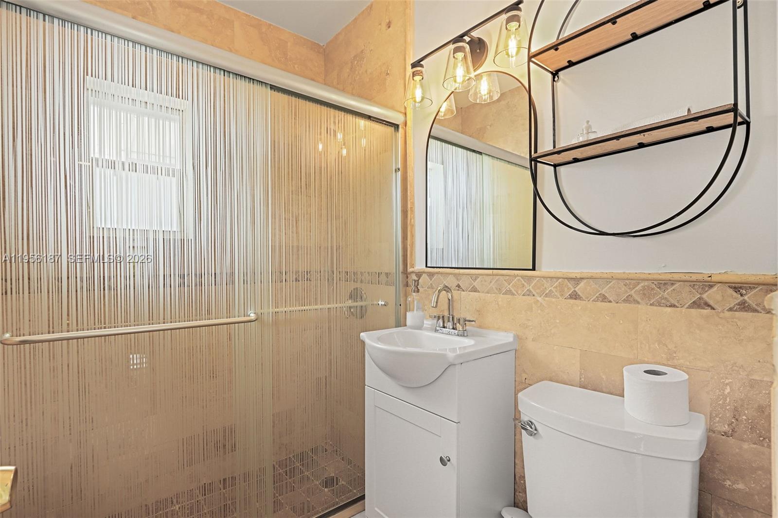 6050 Southwest 44th Terrace Miami, FL 33155 - Photo 15 of 18 a bathroom with a granite countertop sink a mirror and a shower