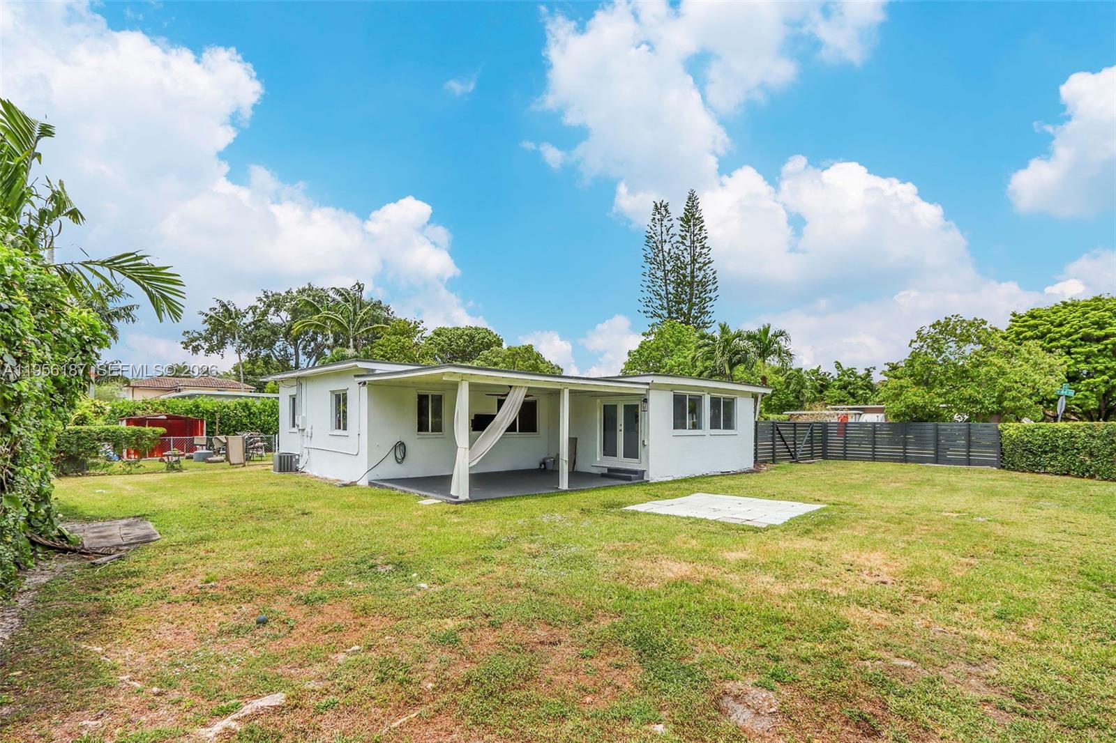 6050 Southwest 44th Terrace Miami, FL 33155 - Photo 7 of 18 a view of a house with a yard patio and fire pit