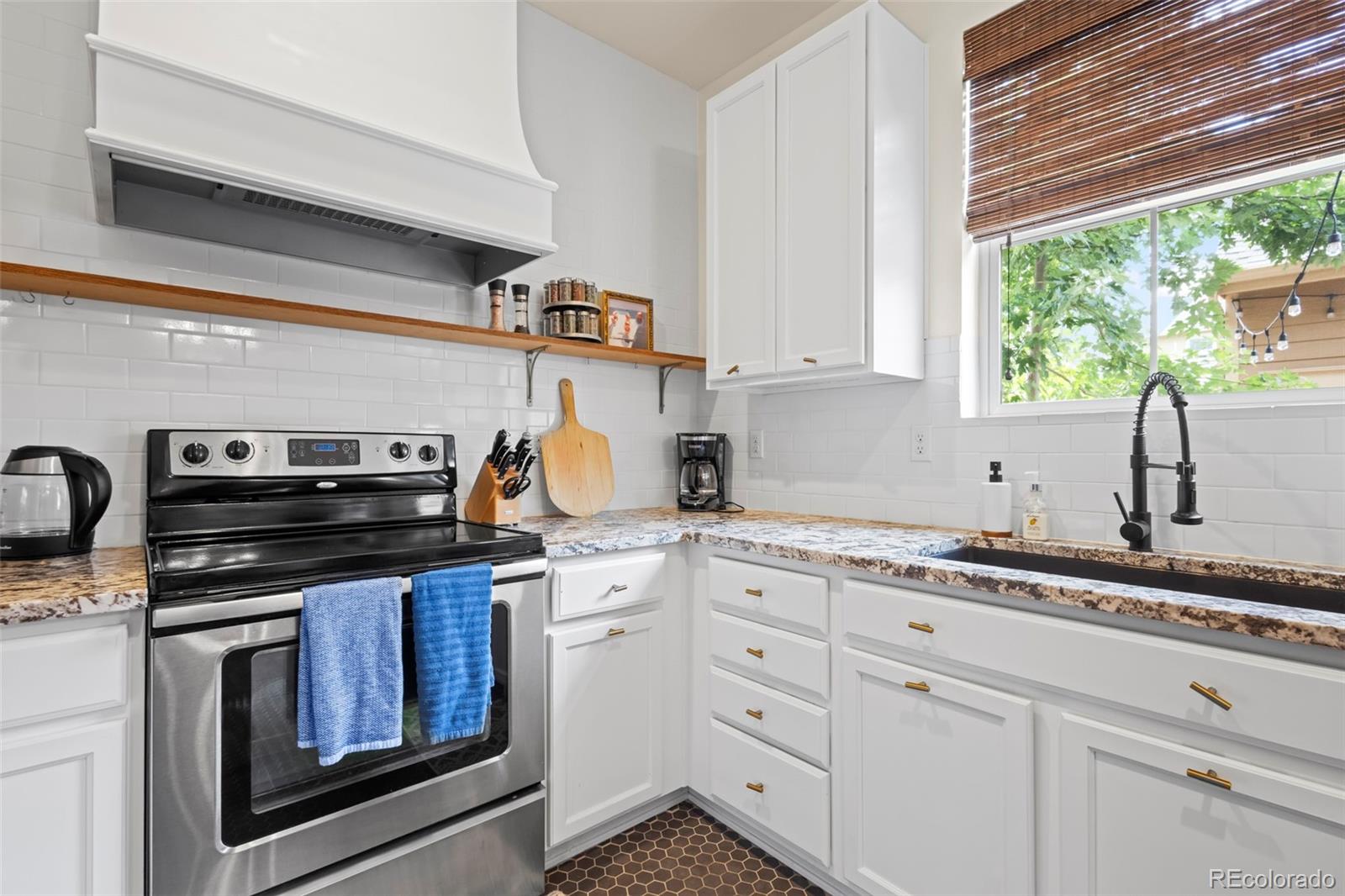 10281 Bellwether Lane Lone Tree, CO 80124 - Photo 12 of 47 a kitchen with appliances a sink and cabinets