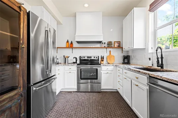 a kitchen with a refrigerator stove and sink