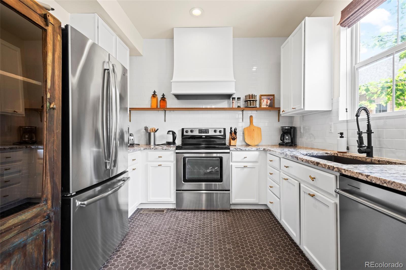10281 Bellwether Lane Lone Tree, CO 80124 - Photo 13 of 47 a kitchen with a refrigerator stove and sink