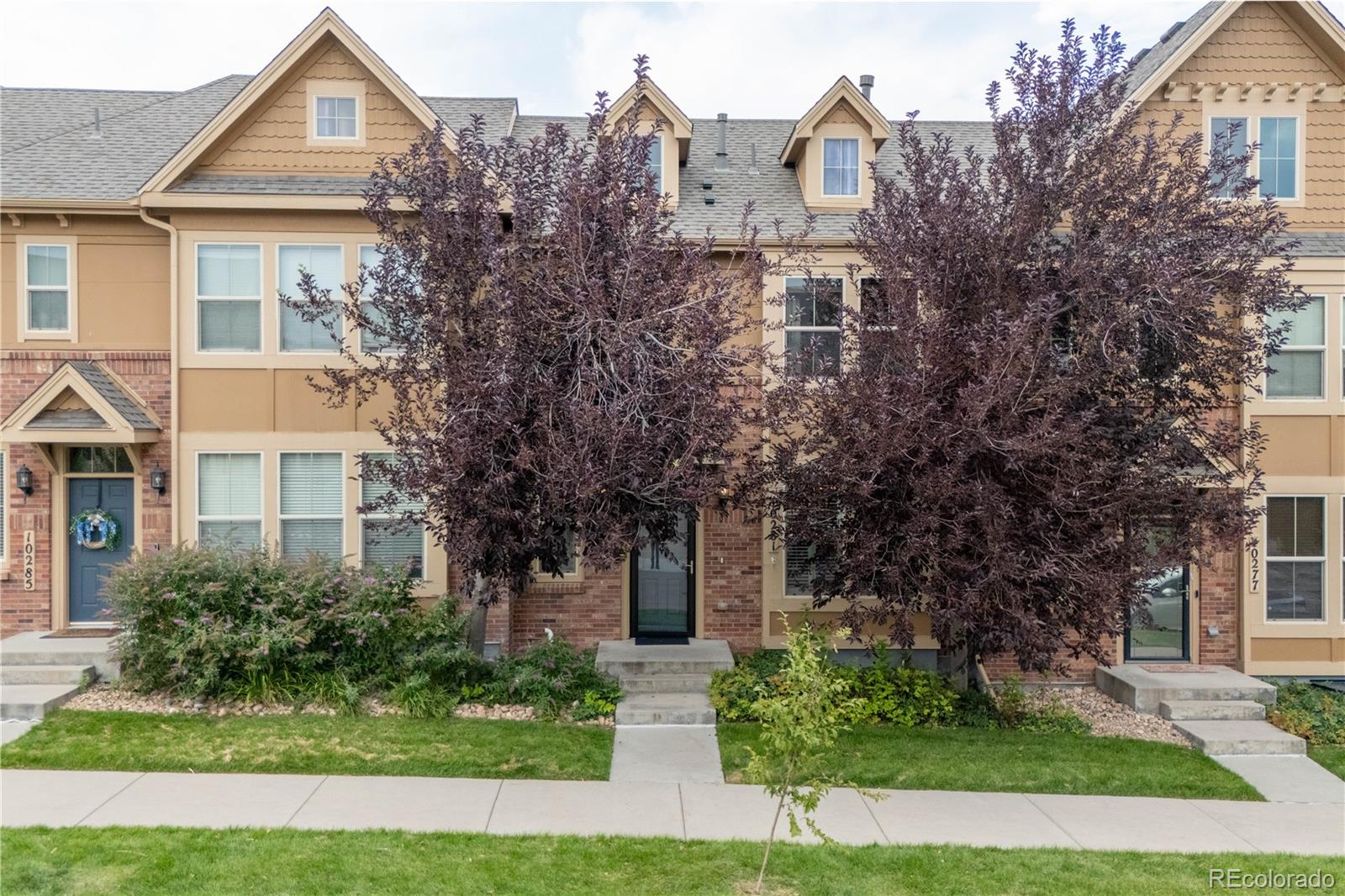 10281 Bellwether Lane Lone Tree, CO 80124 - Photo 2 of 47 front view of a house with a yard