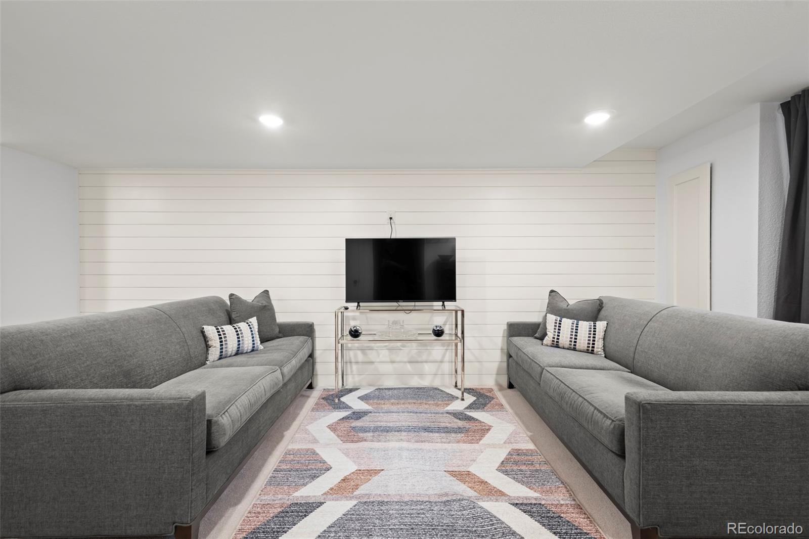 10281 Bellwether Lane Lone Tree, CO 80124 - Photo 22 of 47 a living room with furniture and a flat screen tv