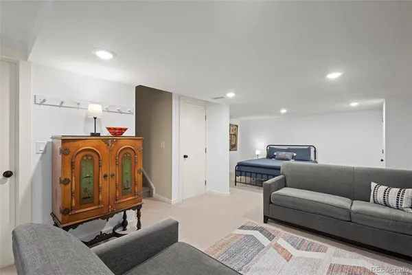 a living room with furniture and a washer dryer