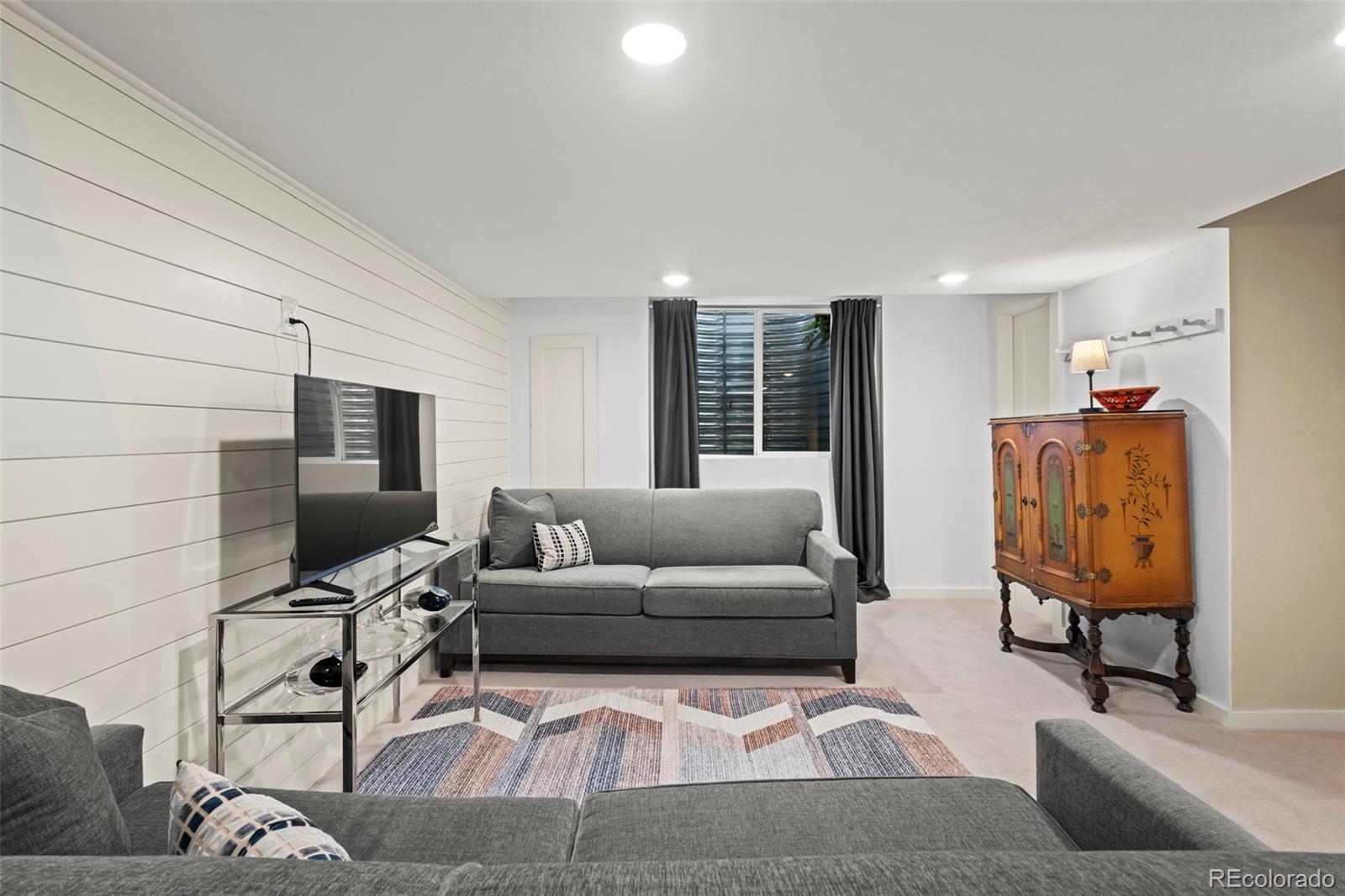 10281 Bellwether Lane Lone Tree, CO 80124 - Photo 24 of 47 a living room with furniture and a flat screen tv