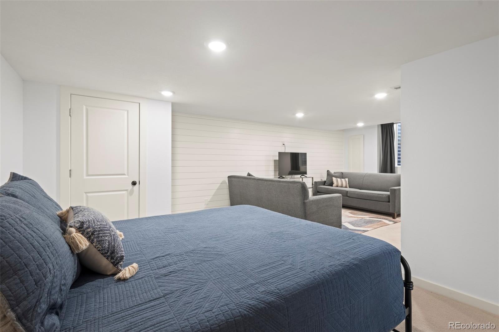 10281 Bellwether Lane Lone Tree, CO 80124 - Photo 27 of 47 a bedroom with a bed and a couch