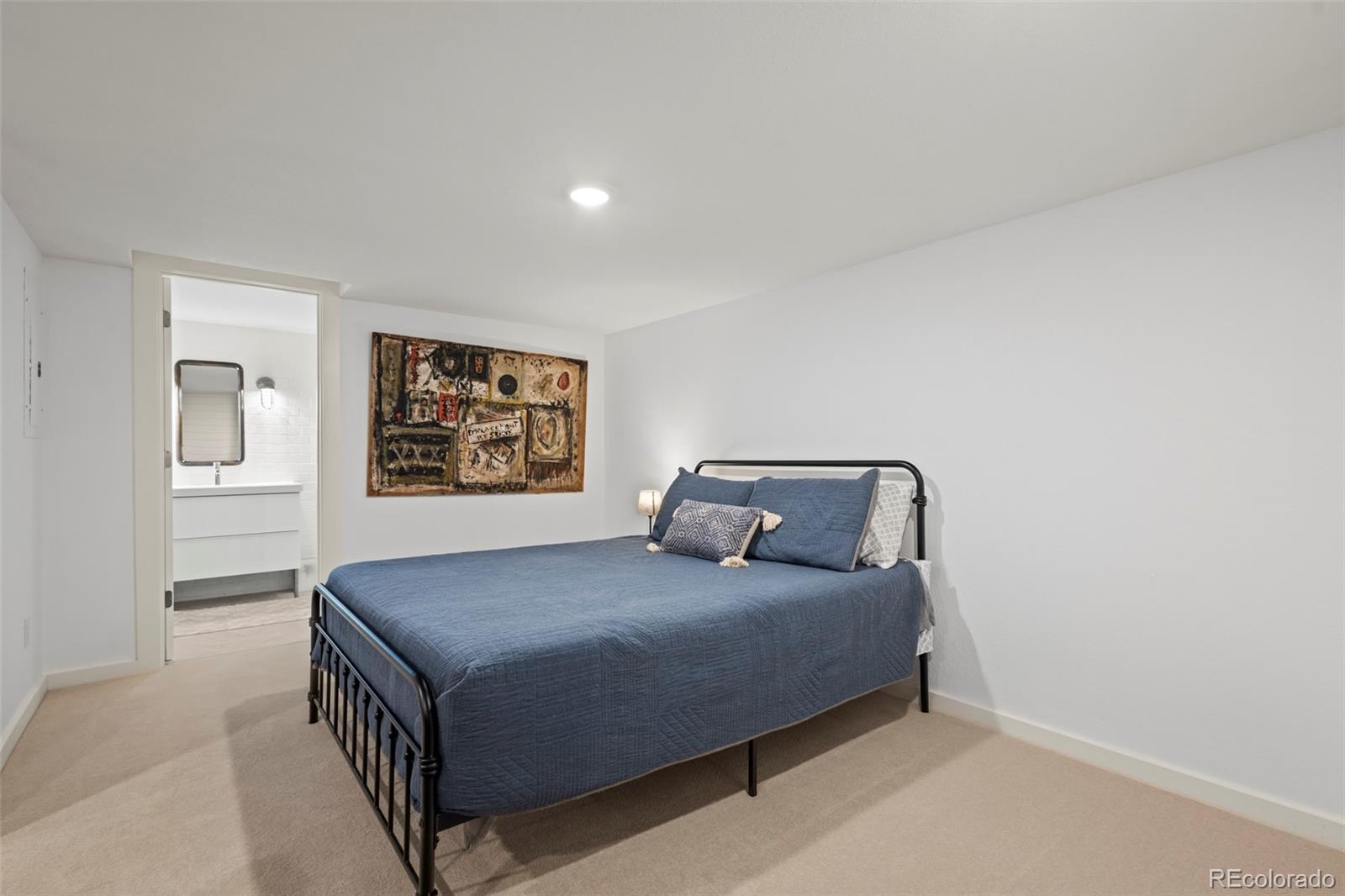 10281 Bellwether Lane Lone Tree, CO 80124 - Photo 28 of 47 a bedroom with a bed and painting on the wall