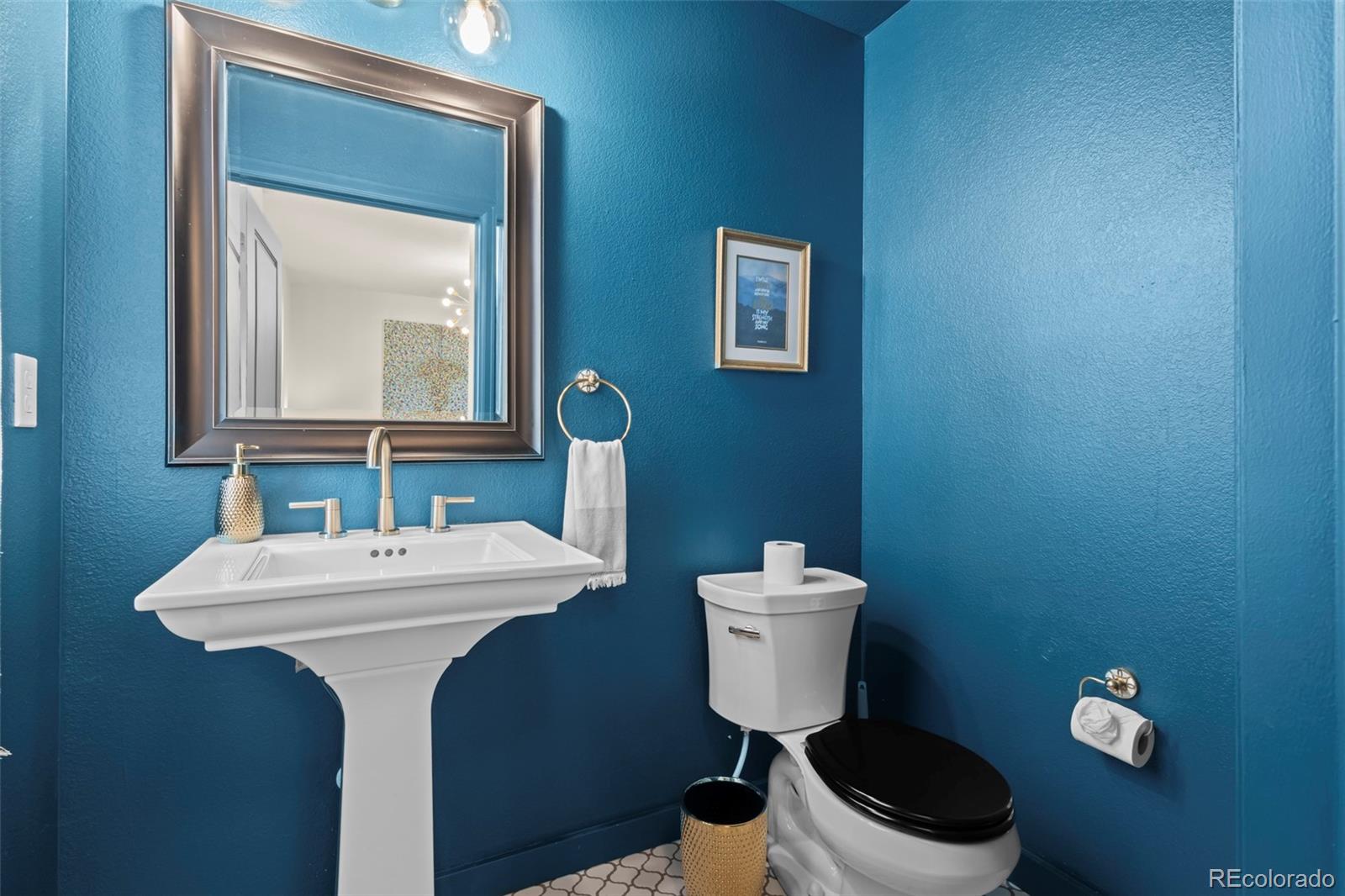 10281 Bellwether Lane Lone Tree, CO 80124 - Photo 31 of 47 a bathroom with a toilet sink and mirror