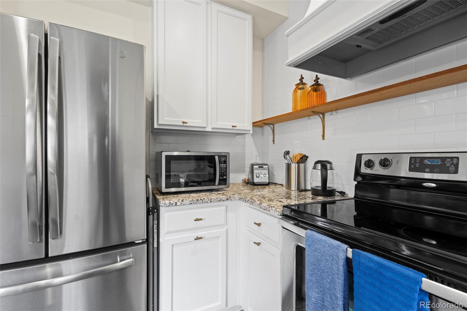10281 Bellwether Lane Lone Tree, CO 80124 - Photo 6 of 47 a kitchen with stainless steel appliances granite countertop a refrigerator stove and sink
