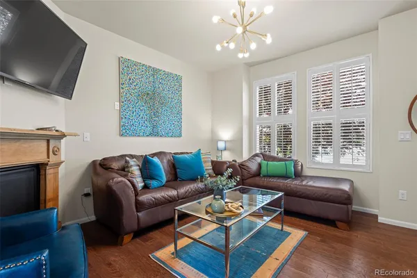 a living room with furniture a flat screen tv and a window
