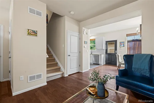 a living room with furniture and wooden floor