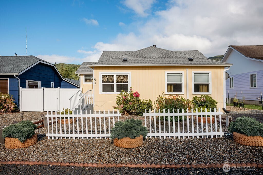a front view of a house with a garden