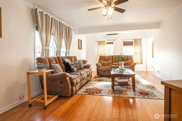 a living room with furniture window and wooden floor