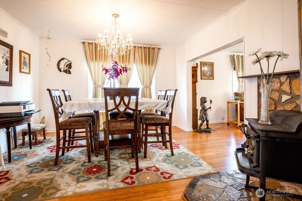 404 Jackson Street Ryderwood, WA 98581 - Photo 16 of 27 a view of a dining room with furniture a chandelier and wooden floor