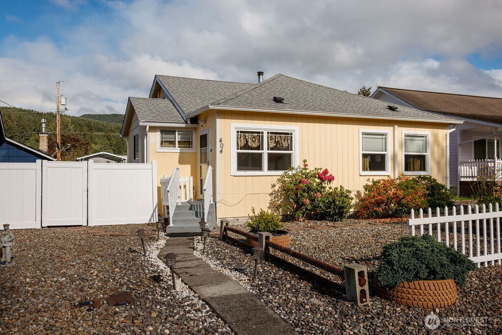 404 Jackson Street Ryderwood, WA 98581 - Photo 2 of 27 a front view of a house with garden