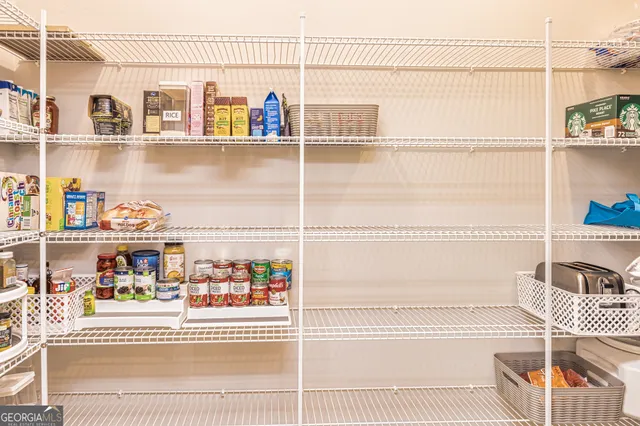 a kitchen with white cabinets and a stove top oven