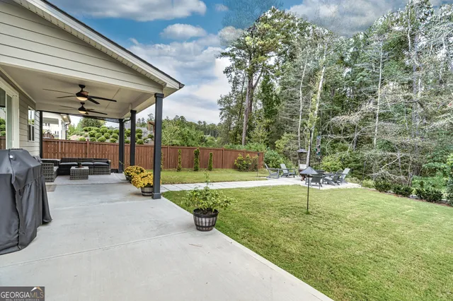 a swimming pool with outdoor seating and yard