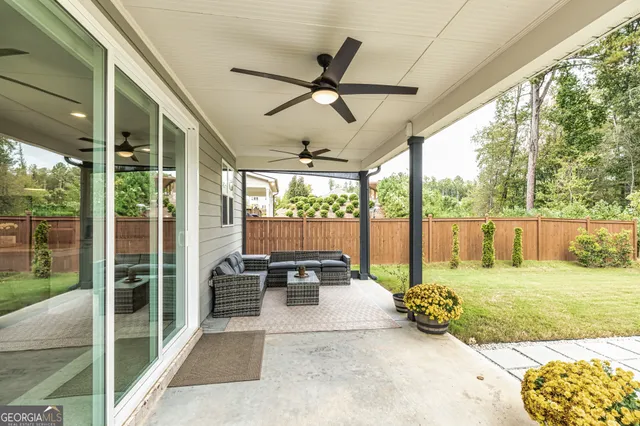 a view of a swimming pool with outdoor seating and plants