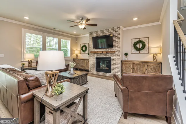 a living room with furniture fireplace and flat screen tv