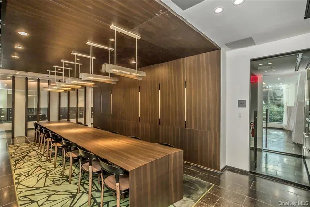 a dinning table and chairs in front of a house