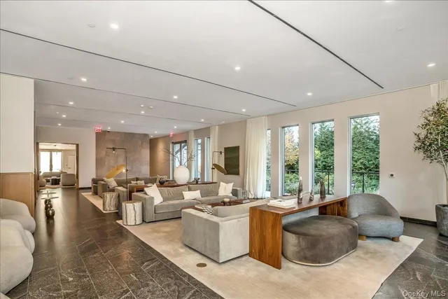 a living room with furniture and large windows