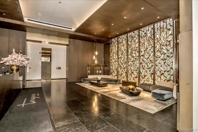 a large kitchen with kitchen island a large window a sink and stainless steel appliances