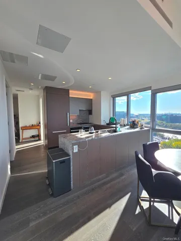 a living room with furniture and floor to ceiling window