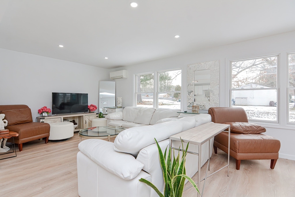 257 Brook Circle Hanover, MA 02339 - Photo 11 of 23 a living room with furniture and a flat screen tv
