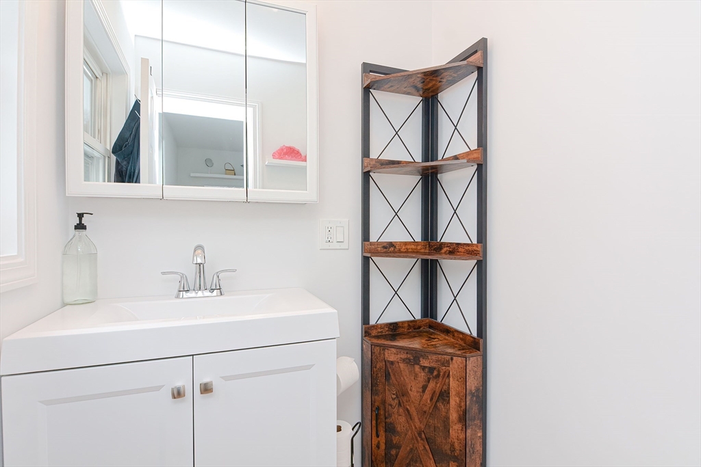 257 Brook Circle Hanover, MA 02339 - Photo 14 of 23 a bathroom with a sink a mirror and a window