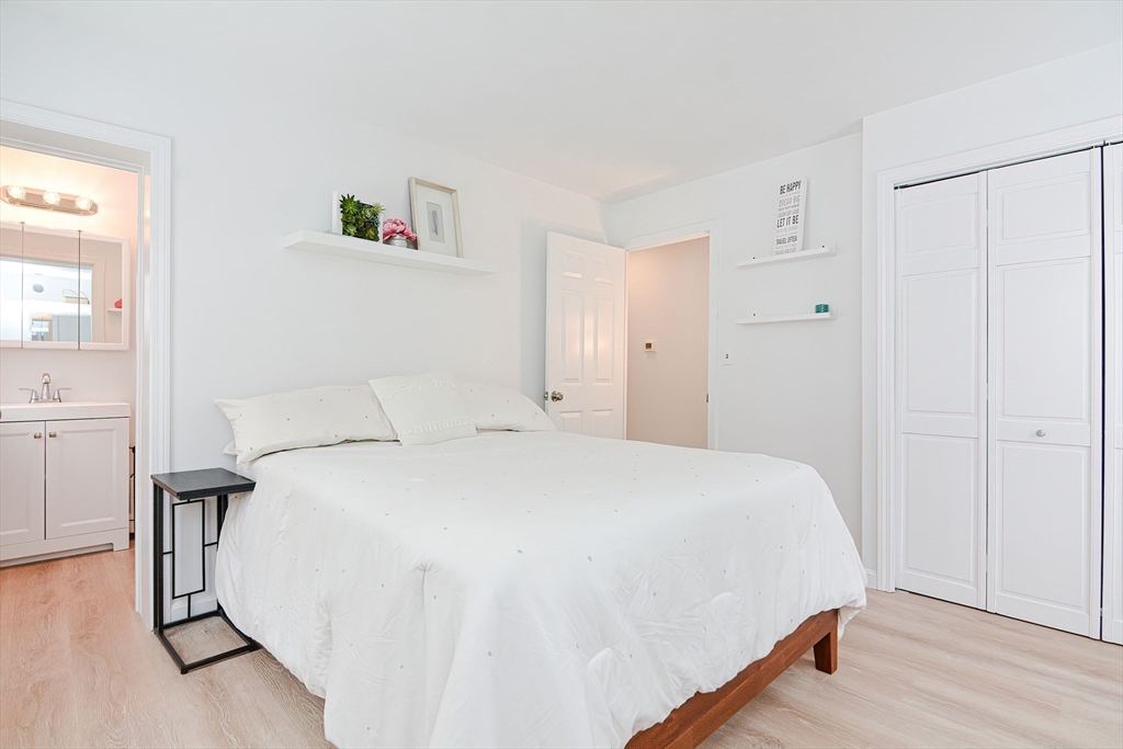 257 Brook Circle Hanover, MA 02339 - Photo 18 of 23 a bedroom with a bed and a table