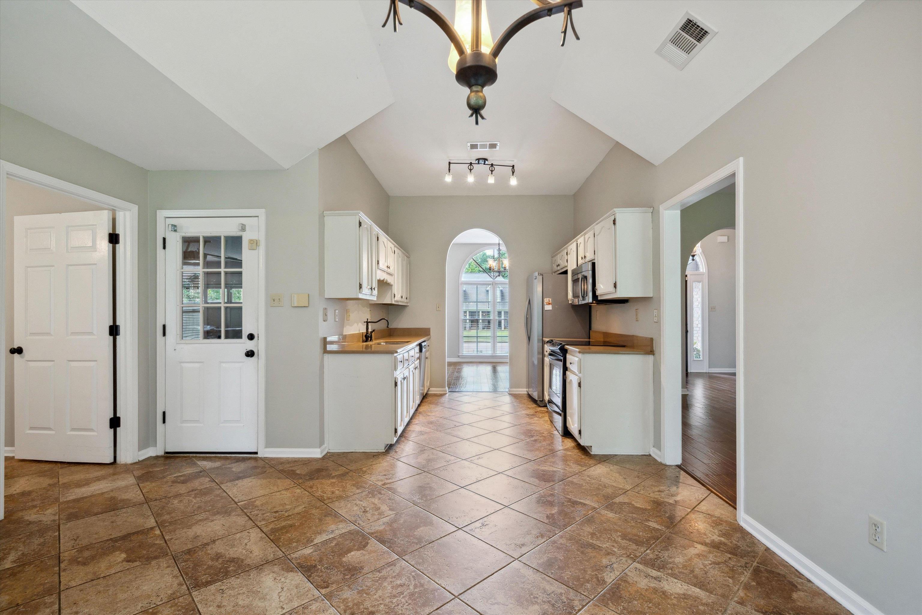 852 Joe Drive Collierville, TN 38017 - Photo 12 of 27 a view of a kitchen with a sink and refrigerator