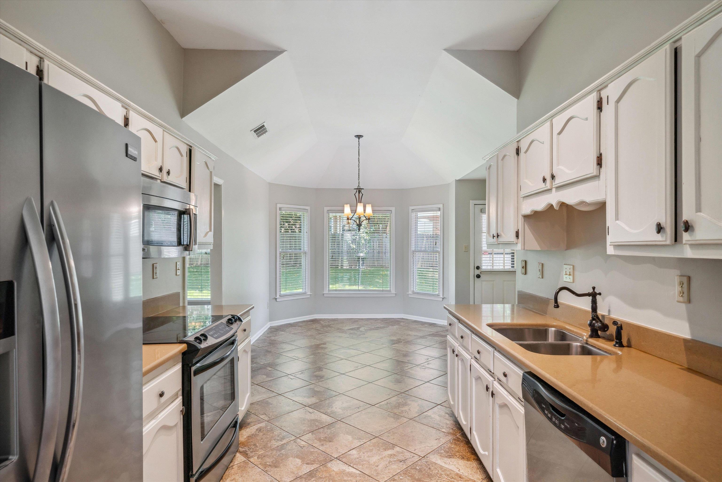 852 Joe Drive Collierville, TN 38017 - Photo 15 of 27 a kitchen with stainless steel appliances granite countertop a sink stove and refrigerator