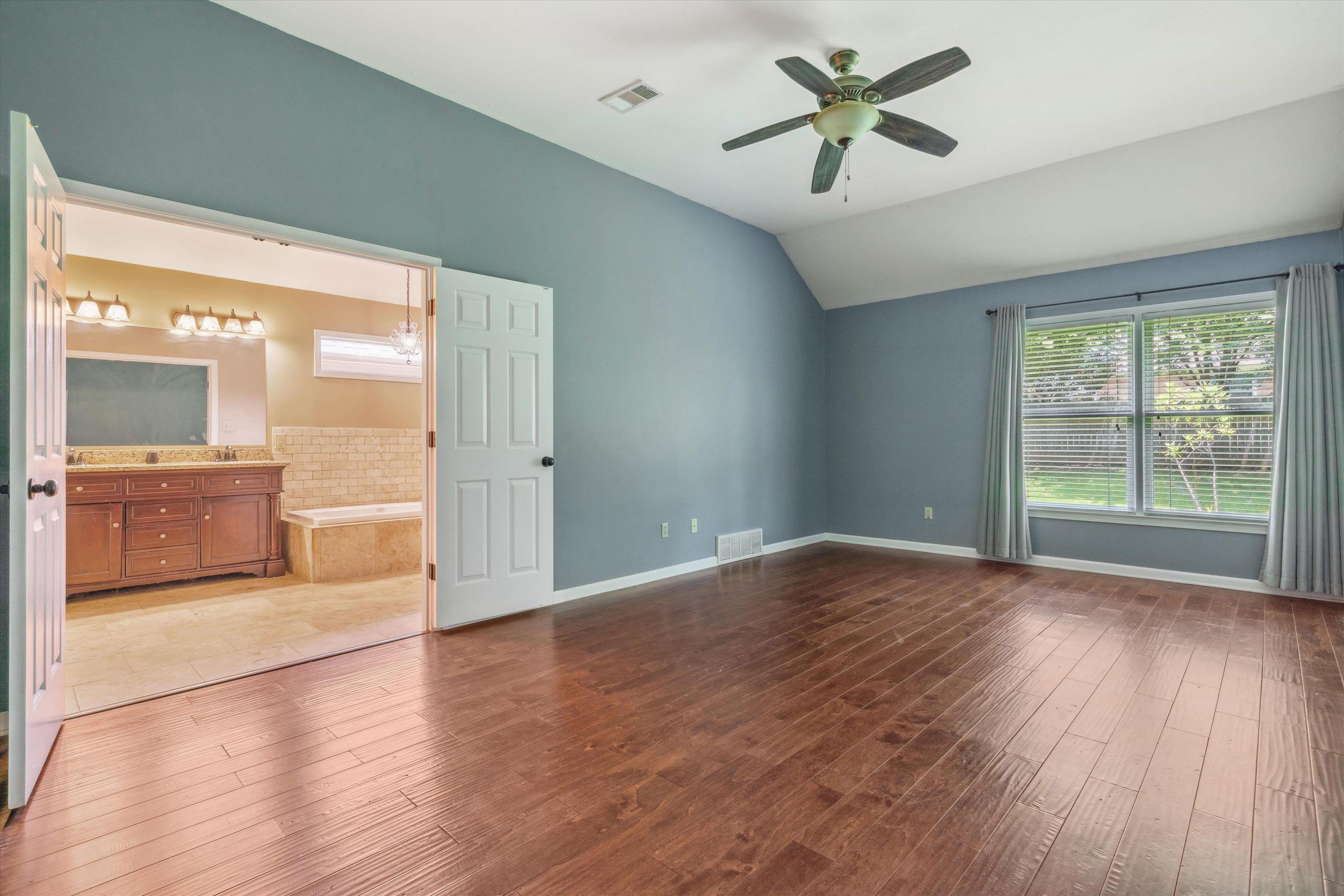 852 Joe Drive Collierville, TN 38017 - Photo 18 of 27 a view of a livingroom with a chandelier fan and wooden floor