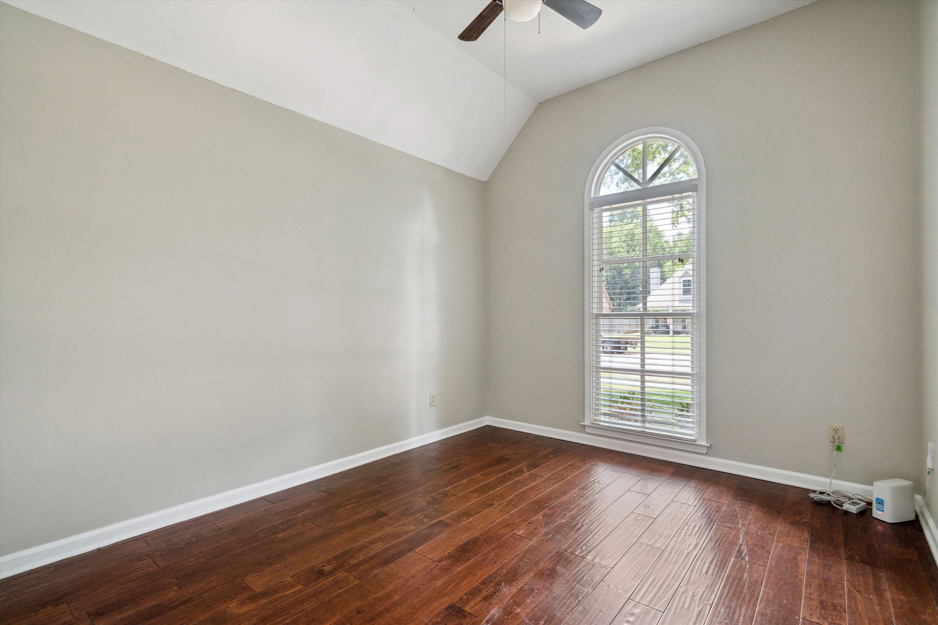 852 Joe Drive Collierville, TN 38017 - Photo 22 of 27 an empty room with wooden floor and windows