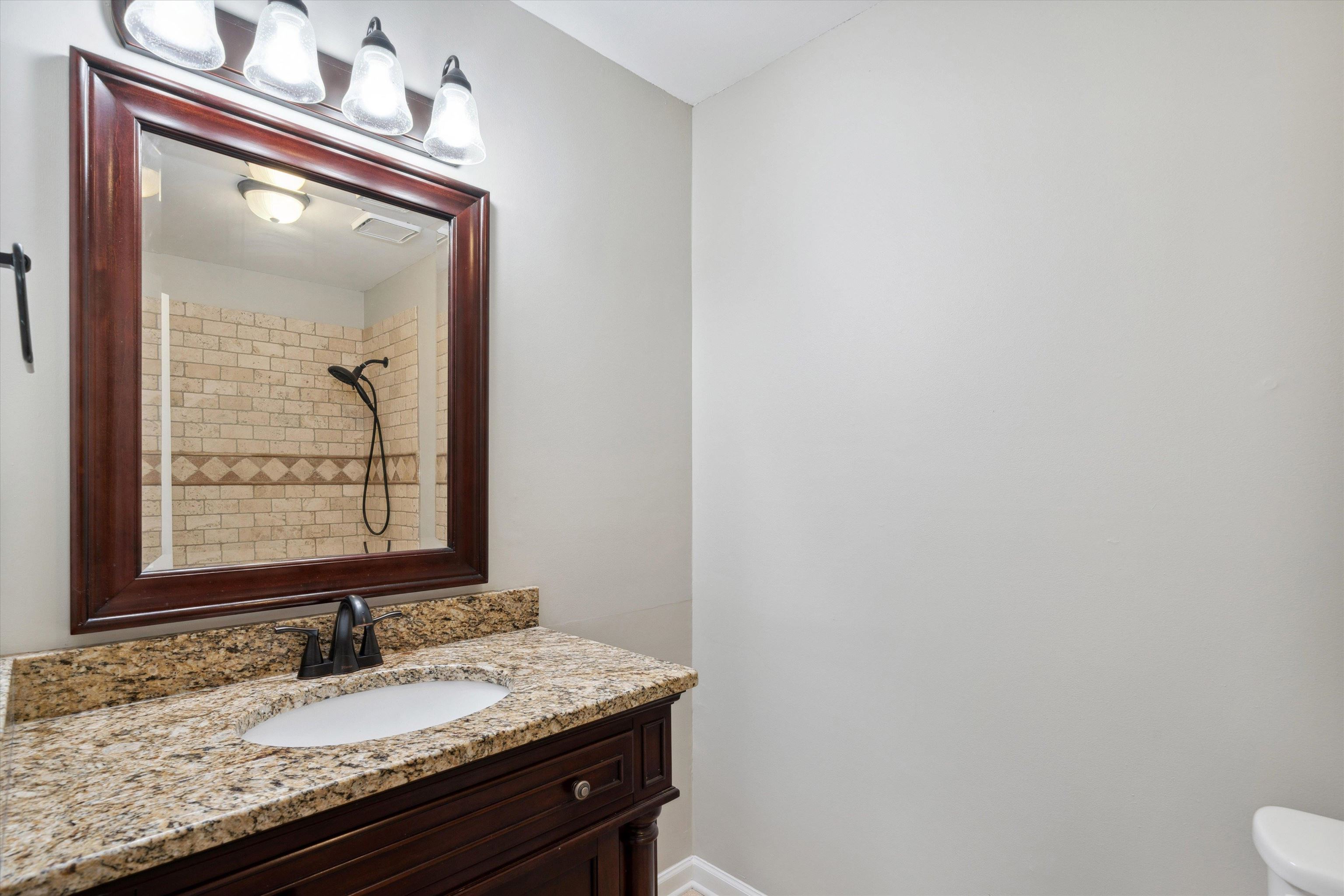 852 Joe Drive Collierville, TN 38017 - Photo 24 of 27 a bathroom with a granite countertop sink and a mirror