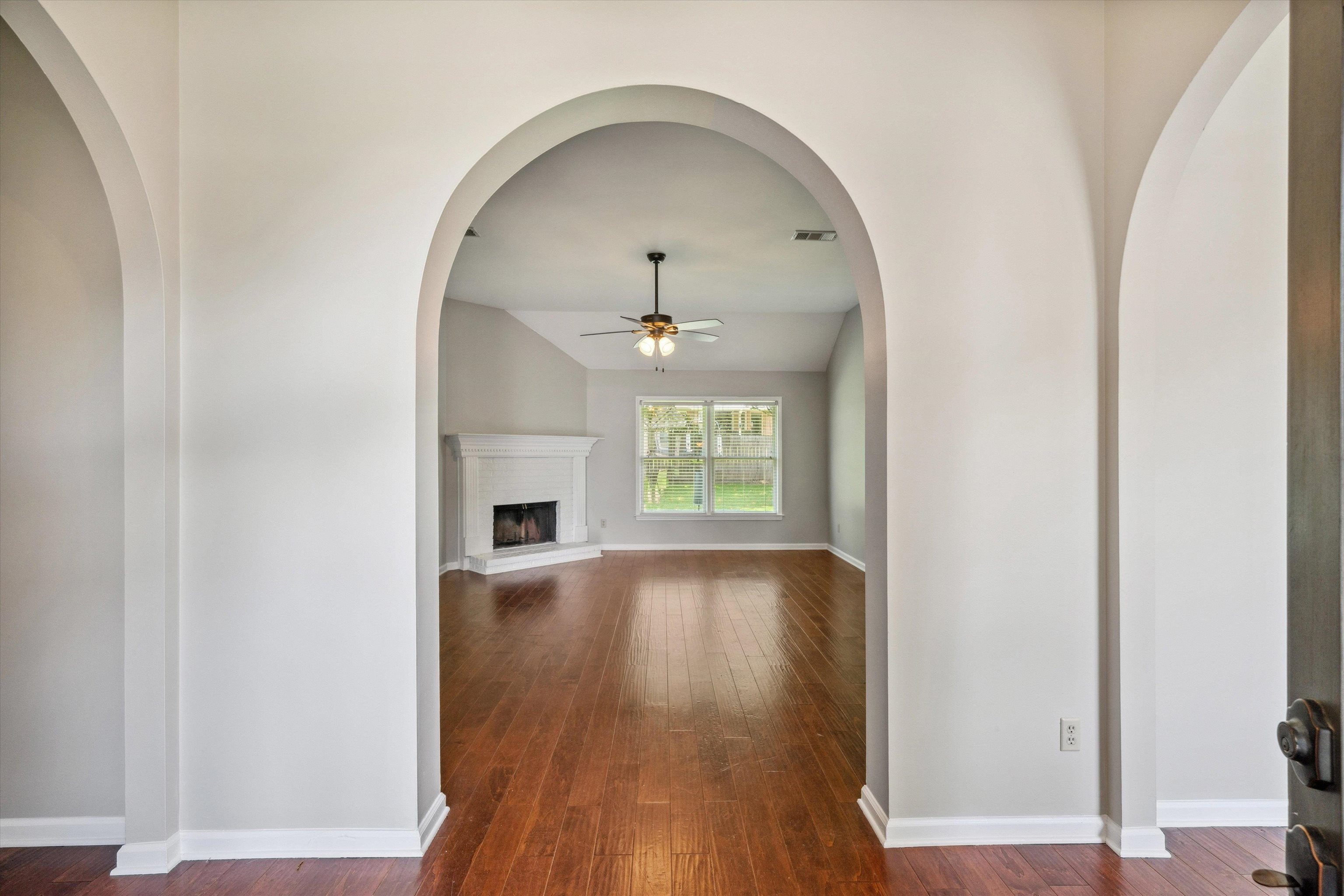 852 Joe Drive Collierville, TN 38017 - Photo 3 of 27 a view of empty room with wooden floor and fan