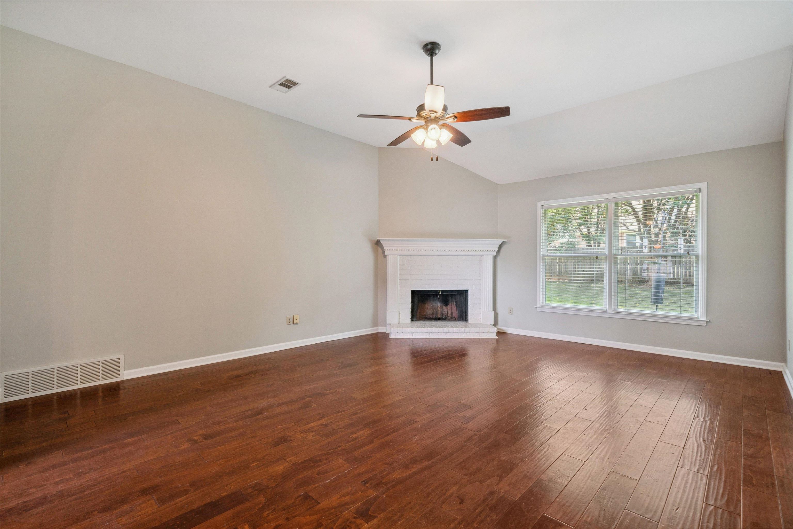 852 Joe Drive Collierville, TN 38017 - Photo 8 of 27 a view of an empty room with wooden floor and a window