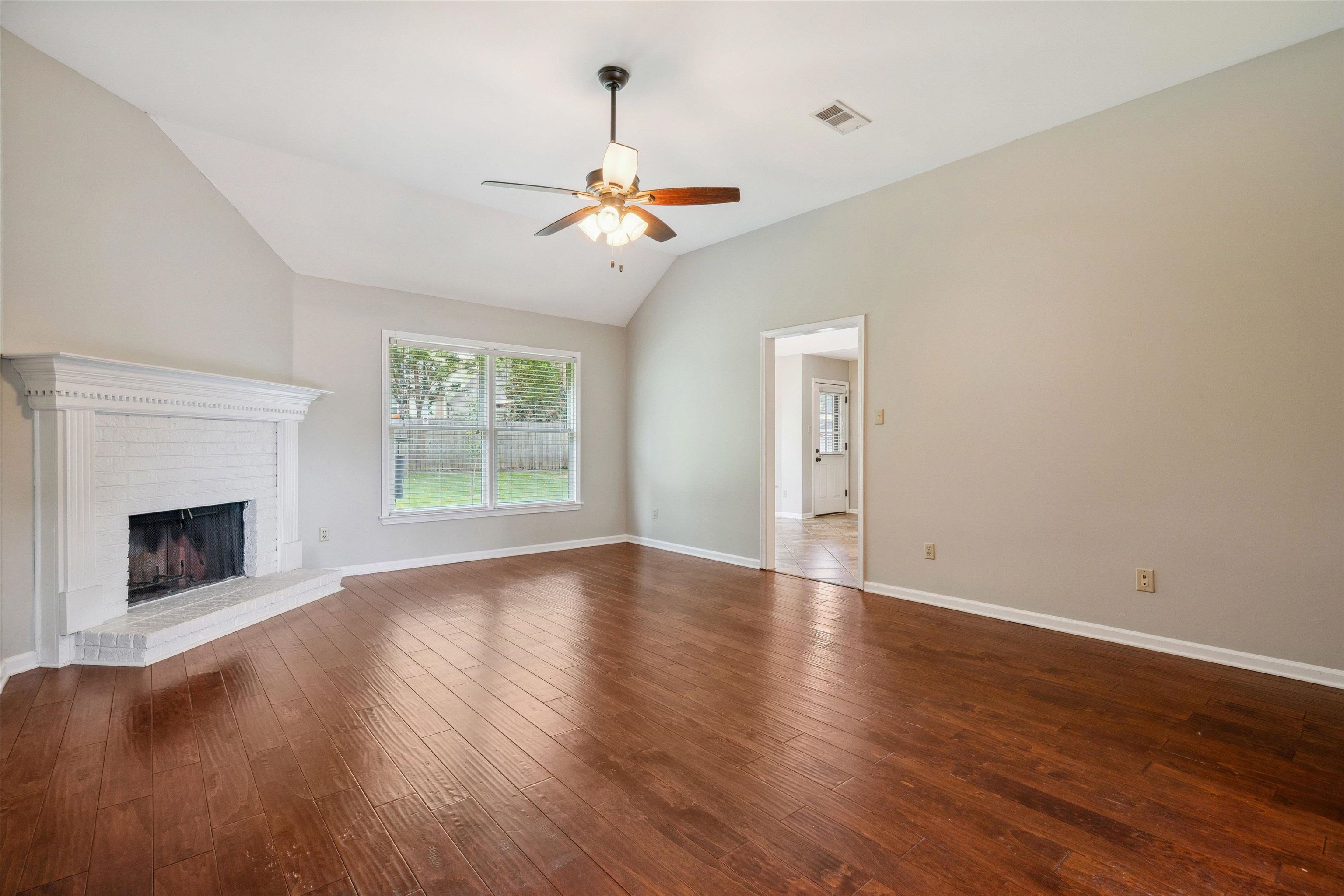 852 Joe Drive Collierville, TN 38017 - Photo 10 of 27 a view of empty room with wooden floor and fireplace
