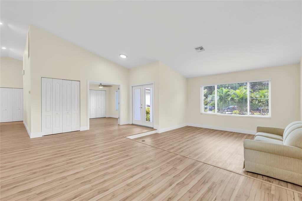 8410 Sawpine Road Delray Beach, FL 33446 - Photo 13 of 37 a view of an empty room with wooden floor and a window